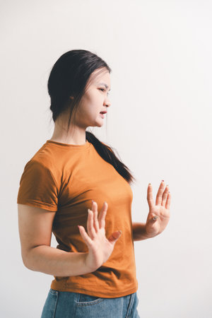 Asian girl expresses dislike, person express negative feeling, concept business complaint from customer ensuring employee satisfaction negative feedback to prevent mental strain customer dislikeの写真素材