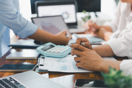 Financial business team in office, financial expert analyze business report graph and finance chart at corporate office. Concept of finance economy, banking business and stock market research.の写真素材