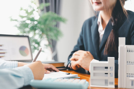 Real estate agents bid home in project to explain in detail to clients. Explain and present information about home and mortgage purchases. real estate trading concept. Real estate trading, buy, sellの写真素材