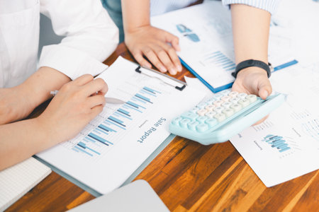 Teamwork with business people analysis cost graph on desk at meeting room. partnership analysis graph company financial budget report, cost work progress planning, business team analysis graph dataの写真素材