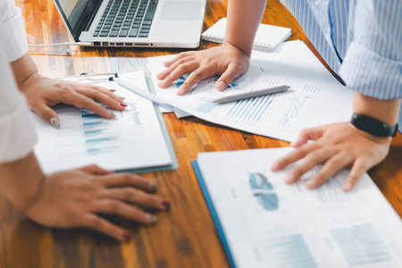 People meeting using laptop computer, calculator, stock market chart paper for analysis plans to improve quality. Team working on project. Analysis business brainstorming corporate smart Concept.の写真素材