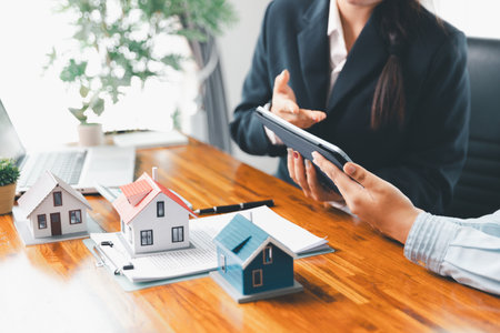 Real estate agents bid home in project to explain in detail to clients. Explain and present information about home and mortgage purchases. real estate trading concept. Real estate trading, buy, sellの写真素材