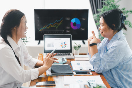 People meeting using laptop computer, calculator, stock market chart paper for analysis plans to improve quality. Team working on project. Analysis business brainstorming corporate smart Concept.の写真素材