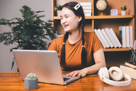 Homeschool Asian girl student learning virtual internet online class from school teacher by remote meeting. Female teaching math by headphone. education concept. student with computer study at schoolの写真素材