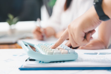 Financial business team in office, financial expert analyze business report graph and finance chart at corporate office. Concept of finance economy, banking business and stock market research.の写真素材
