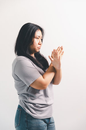 Asian girl expresses dislike, person express negative feeling, concept business complaint from customer ensuring employee satisfaction negative feedback to prevent mental strain customer dislikeの写真素材