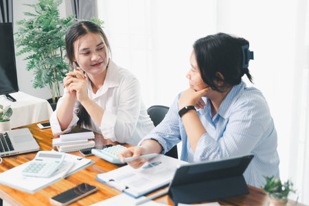 People meeting using laptop computer, calculator, stock market chart paper for analysis plans to improve quality. Team working on project. Analysis business brainstorming corporate smart Concept.の写真素材