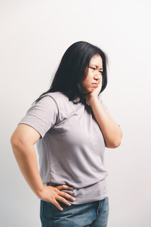 Asian girl expresses dislike, person express negative feeling, concept business complaint from customer ensuring employee satisfaction negative feedback to prevent mental strain customer dislikeの写真素材
