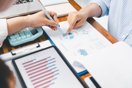 Teamwork with business people analysis cost graph on desk at meeting room. partnership analysis graph company financial budget report, cost work progress planning, business team analysis graph dataの写真素材