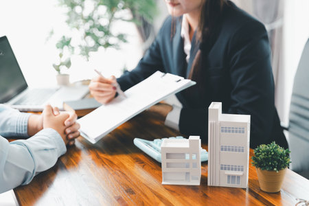 Real estate agent delivering sample home to customer, mortgage loan contract. Contract for hire purchase sale of house. home insurance contract, home mortgage loan concept. real estate, customerの写真素材