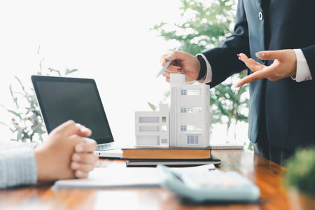 Real estate agents bid home in project to explain in detail to clients. Explain and present information about home and mortgage purchases. real estate trading concept. Real estate trading, buy, sellの写真素材
