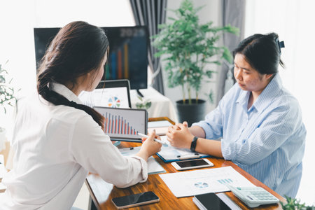 People meeting using laptop computer, calculator, stock market chart paper for analysis plans to improve quality. Team working on project. Analysis business brainstorming corporate smart Concept.の写真素材