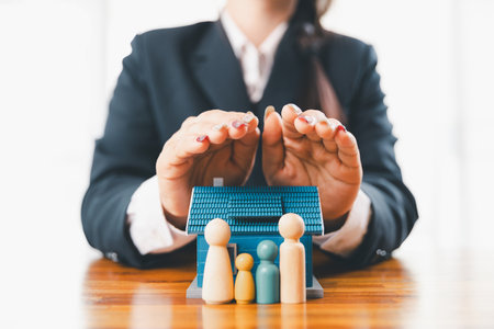 Home insurance and security concept. Real estate house insurance. Domino chain challenge risk. insurance risk management, property security, financial planning to safety, mortgage protect investmentの写真素材
