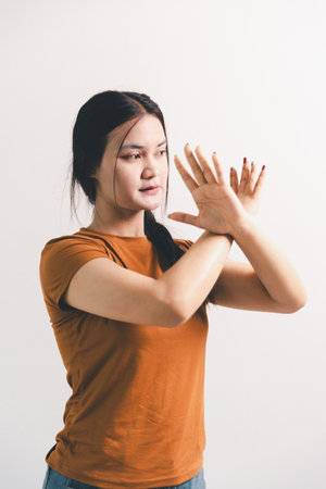 Asian girl expresses dislike, person express negative feeling, concept business complaint from customer ensuring employee satisfaction negative feedback to prevent mental strainの写真素材