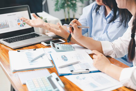 Teamwork with business people analysis cost graph on desk at meeting room. partnership analysis graph company financial budget report, cost work progress planning, business team analysis graph dataの写真素材