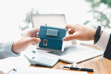 Real estate agents bid home in project to explain in detail to clients. Explain and present information about home and mortgage purchases. real estate trading concept. Real estate trading, buy, sellの写真素材