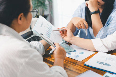 Teamwork with business people analysis cost graph on desk at meeting room. partnership analysis graph company financial budget report, cost work progress planning, business team analysis graph dataの写真素材