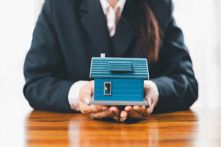 Home insurance and security concept. Real estate house insurance. Domino chain challenge risk. insurance risk management, property security, financial planning to safety, mortgage protect investmentの写真素材