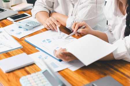 Teamwork with business people analysis cost graph on desk at meeting room. partnership analysis graph company financial budget report, cost work progress planning, business team analysis graph dataの写真素材