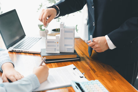 Real estate agent delivering sample home to customer, mortgage loan contract. Contract for hire purchase sale of house. home insurance contract, home mortgage loan concept. real estate, customerの写真素材