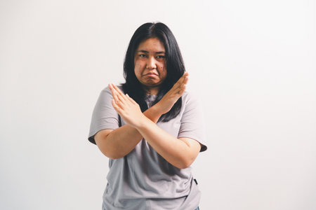 Asian girl expresses dislike, person express negative feeling, concept business complaint from customer ensuring employee satisfaction negative feedback to prevent mental strainの写真素材