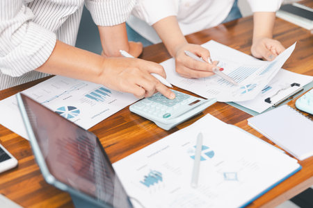 Financial business team in office, financial expert analyze business report graph and finance chart at corporate office. Concept of finance economy, banking business and stock market research.の写真素材