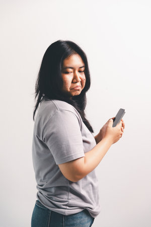 Asian girl expresses dislike, person express negative feeling, concept business complaint from customer ensuring employee satisfaction negative feedback to prevent mental strain customer dislikeの写真素材