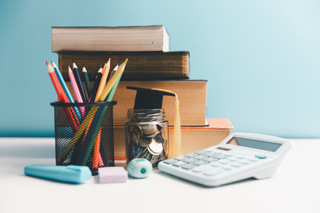 Concept of saving money for education, student loan, scholarship in future. Piggy bank with graduation hat, stack of coins. Earth globe with graduation hat, dollar banknotes on table. Tuition feesの写真素材