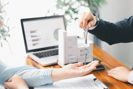Real estate agent delivering sample home to customer, mortgage loan contract. Contract for hire purchase sale of house. home insurance contract, home mortgage loan concept. real estate, customerの写真素材