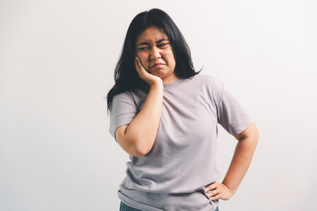 Asian girl expresses dislike, person express negative feeling, concept business complaint from customer ensuring employee satisfaction negative feedback to prevent mental strain customer dislikeの写真素材