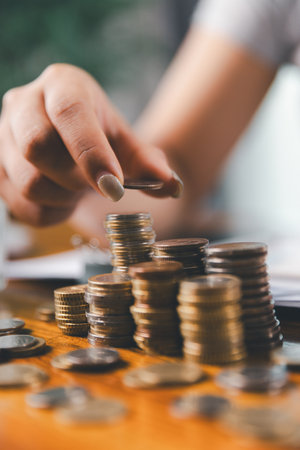 Businesswoman saving money with piggy bank and coins on desk, financial planning and investment...
