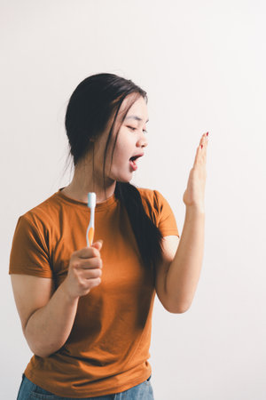 Asian girl expresses dislike, person express negative feeling, concept business complaint from customer ensuring employee satisfaction negative feedback to prevent mental strainの写真素材