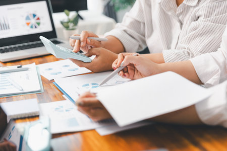 Financial business team in office, financial expert analyze business report graph and finance chart at corporate office. Concept of finance economy, banking business and stock market research.の写真素材