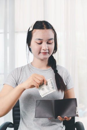 Business, finance and employment, entrepreneur and money concept. Successful young office manager, businesswoman showing earned cash, smiling satisfied holding dollars, money dollar billsの写真素材