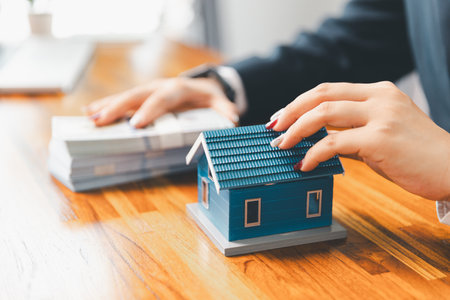 Property buyer with banknotes and buy from real estate agencies in office. Explain present information about home and mortgage purchases. real estate trading concept. Real estate trading, buy, sellの写真素材