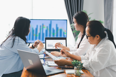 Financial business team in office, financial expert analyze business report graph and finance chart at corporate office. Concept of finance economy, banking business and stock market research.の写真素材