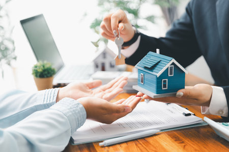 Real estate agent delivering sample home to customer, mortgage loan contract. Contract for hire purchase sale of house. home insurance contract, home mortgage loan concept. real estate, customerの写真素材