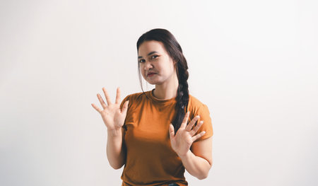 Asian girl expresses dislike, person express negative feeling, concept business complaint from customer ensuring employee satisfaction negative feedback to prevent mental strainの写真素材