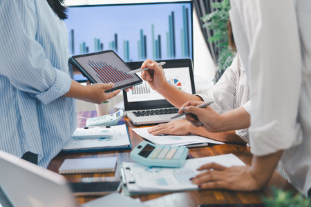 Teamwork with business people analysis cost graph on desk at meeting room. partnership analysis graph company financial budget report, cost work progress planning, business team analysis graph dataの写真素材