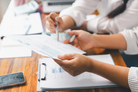 Financial business team in office, financial expert analyze business report graph and finance chart at corporate office. Concept of finance economy, banking business and stock market research.の写真素材