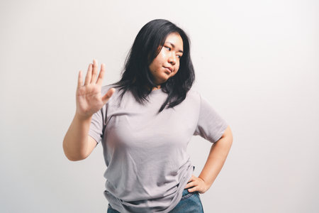 Asian girl expresses dislike, person express negative feeling, concept business complaint from customer ensuring employee satisfaction negative feedback to prevent mental strain customer dislikeの写真素材