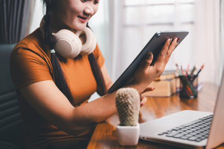 Homeschool Asian girl student learning virtual internet online class from school teacher by remote meeting. Female teaching math by headphone. education concept. student with computer study at schoolの写真素材