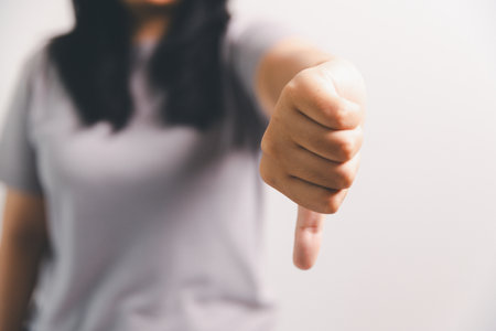 Asian girl expresses dislike, person express negative feeling, concept business complaint from...