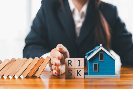 Home insurance and security concept. Real estate house insurance. Domino chain challenge risk. insurance risk management, property security, financial planning to safety, mortgage protect investmentの写真素材