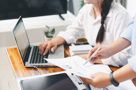 Financial business team in office, financial expert analyze business report graph and finance chart at corporate office. Concept of finance economy, banking business and stock market research.の写真素材