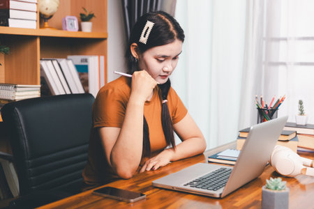 Homeschool Asian girl student learning virtual internet online class from school teacher by remote...