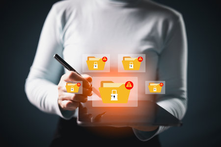 Cybersecurity warning on data folders with lock icons and red warning alerts signs. Represents encryption error, ransomware attack, system breach, digital threat from hacker, malware activity. breachの写真素材
