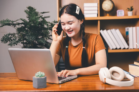 Homeschool Asian girl student learning virtual internet online class from school teacher by remote meeting. Female teaching math by headphone. education concept. student with computer study at schoolの写真素材