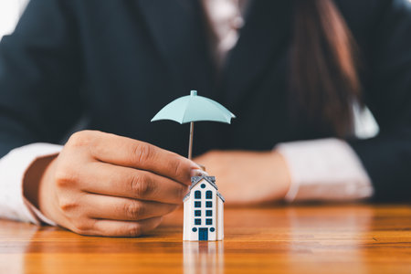 Home insurance and security concept. Real estate house insurance. Domino chain challenge risk. insurance risk management, property security, financial planning to safety, mortgage protect investmentの写真素材