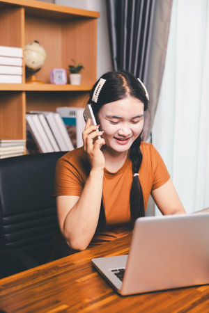 Homeschool Asian girl student learning virtual internet online class from school teacher by remote meeting. Female teaching math by headphone. education concept. student with computer study at schoolの写真素材